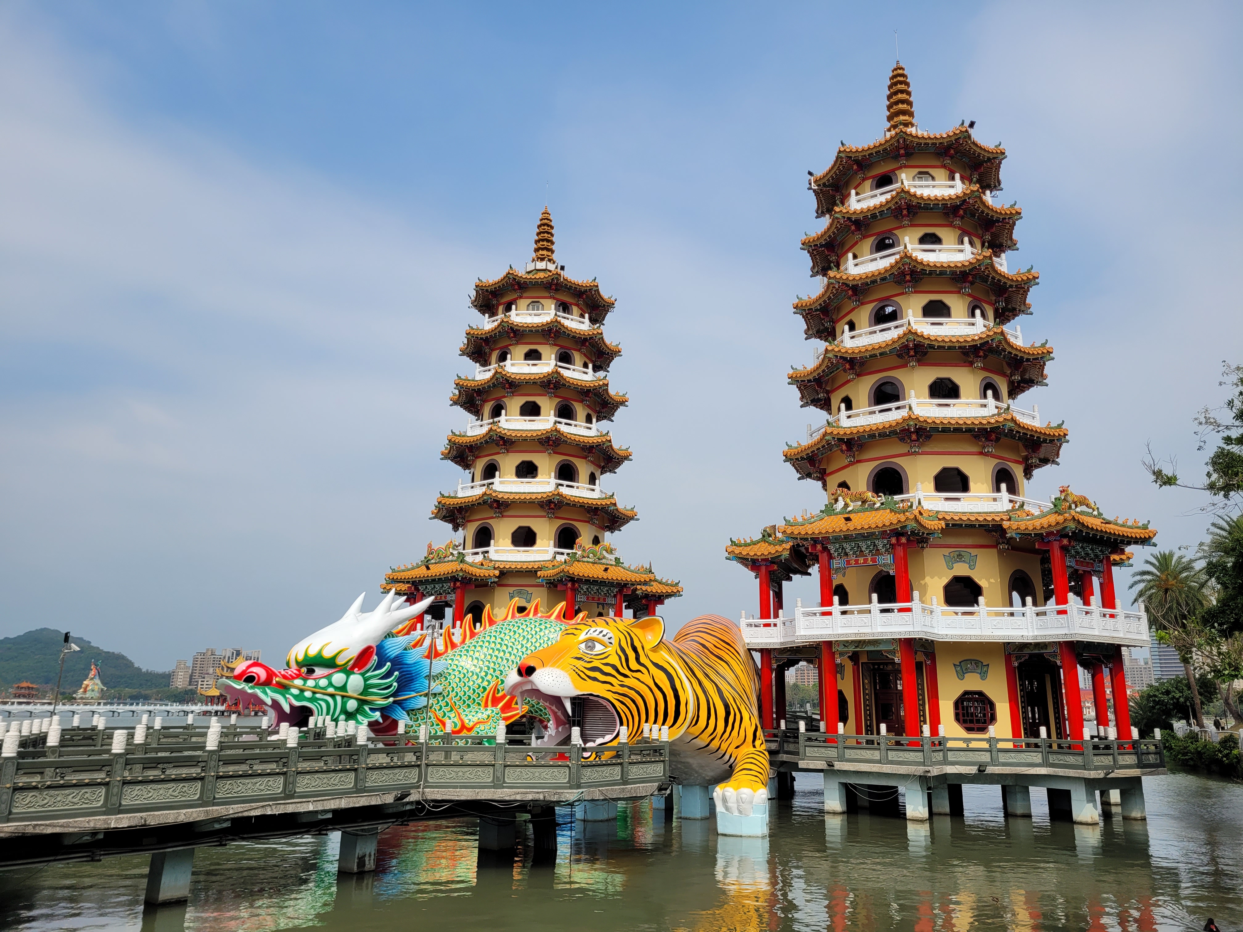 30/03/2025 - Dragon and Tiger Pagodas -
					The Dragon and Tiger Pagodas is a temple constitued of two pagodas located in the Lotus Pond in Kaohsiung.
					The temple was built in 1976 and is decorated with a huge dragon and tiger.
					Both towers are seven storeys tall and have yellow walls, red pillars and orange tiles. A zigzag bridge connects the towers to the shore.