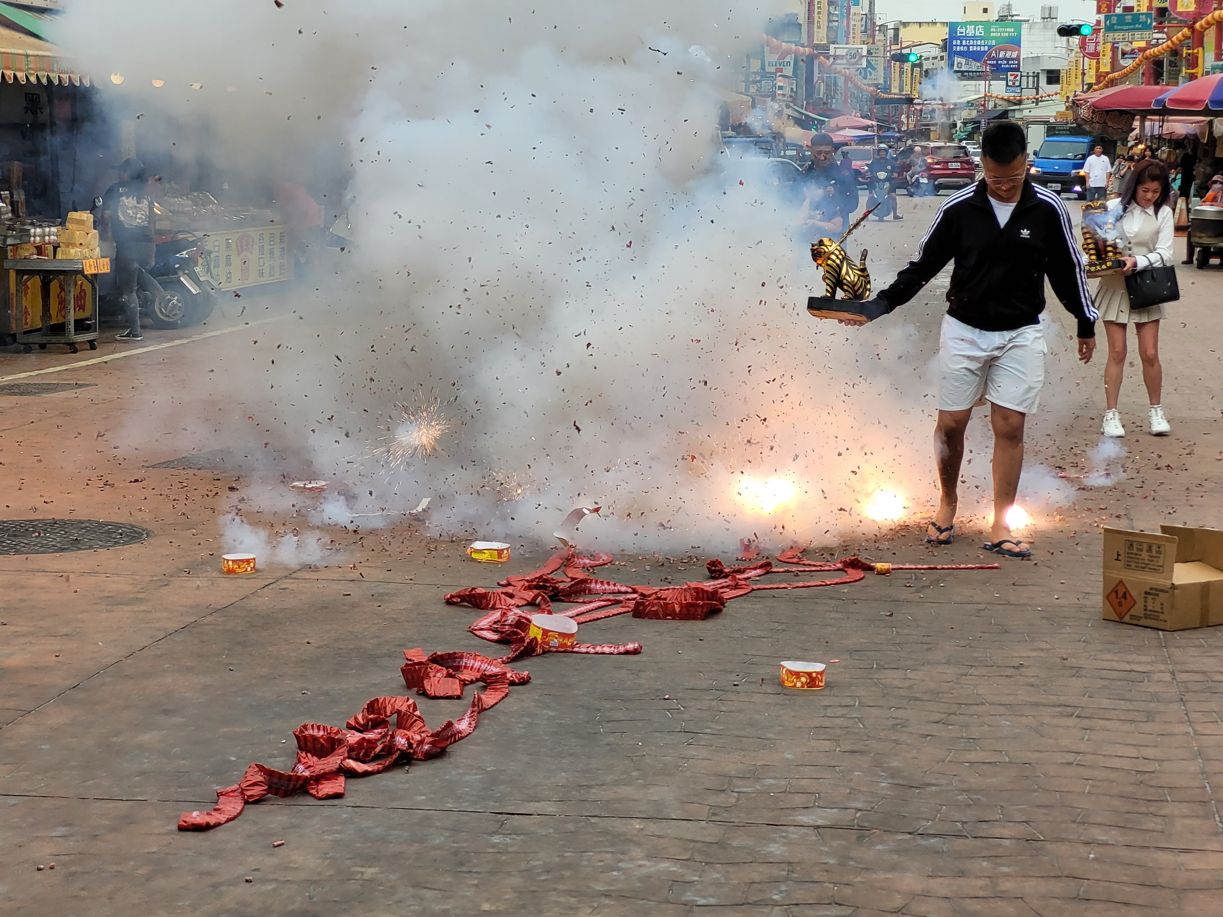 26/04/2025 - Going through firecrackers -
						 To worship the goddess of the sea Mazu, one of the most important deities in Taiwan,
						 the locals set off firecrackers to ward off evil spirits and bring good luck.
						 The guy in the picture is going through the firecrackers to show his devotion to the goddess.